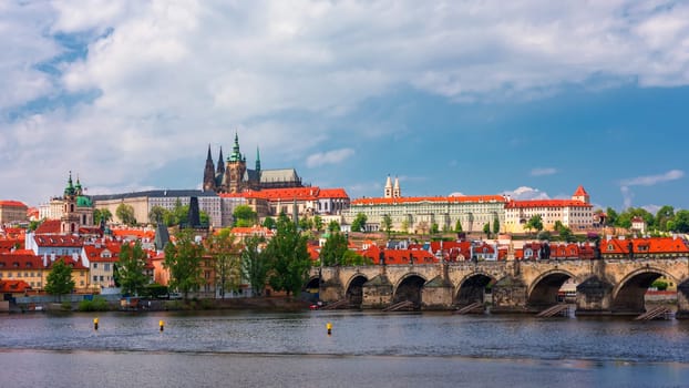 Prague scenic spring view of the Prague Old Town pier architecture Charles Bridge over Vltava river in Prague, Czechia. Old Town of Prague with the Castle in the background, Czech Republic.