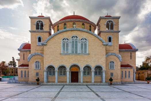 A large, ornate building with a red roof and white trim. The building is a church with a dome on top. Nicosia, Cyprus.