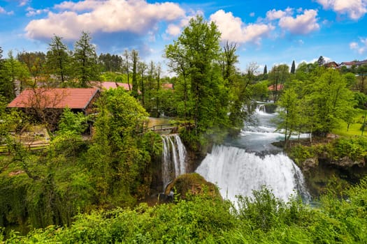 Village of Rastoke near Slunj in Croatia, old water mills on waterfalls of Korana river, beautiful countryside landscape. Landscape with river and little waterfalls in Rastoke village, Croatia.