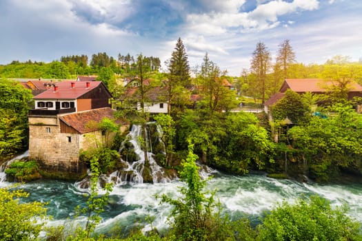 Village of Rastoke near Slunj in Croatia, old water mills on waterfalls of Korana river, beautiful countryside landscape. Landscape with river and little waterfalls in Rastoke village, Croatia.