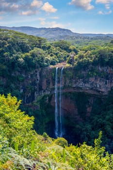The highest waterfall on the island of Mauritius is Chamarel, whose water falls into the crater of a long-extinct volcano. Exotic nature of tropical paradise of Mauritius island, Chamarel waterfall.