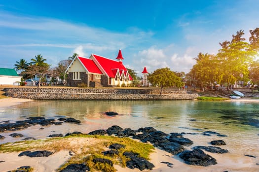 Red church at Cap Malheureux village, Mauritius Island. Notre Dame de Auxiliatrice, rural church with red roof in Cap Malheureux tropical village on Mauritius island, Indian Ocean.
