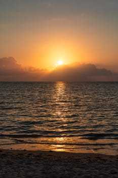 Dramatic colorful sunset sky over sea. Cloudscape nature background. Beautiful sunset over the sea. Sunset over the sea and beautiful cloudscape.