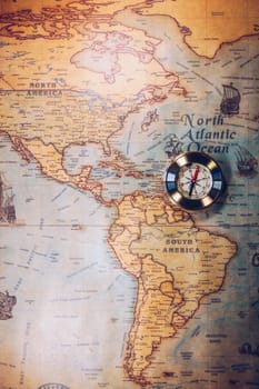 Old vintage retro golden compass on ancient map. Selective focus, shallow depth of field. Concept of world travel, sightseeing and tourism.