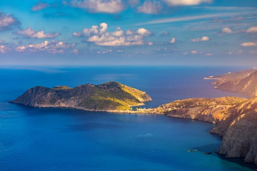 Aerial drone view video of beautiful and picturesque colorful traditional fishing village of Assos in island of Cefalonia, Ionian, Greece. Peninsula of Assos in Cephalonia (Kefalonia), Greece