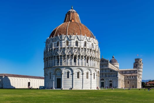 Pisa Cathedral and the Leaning Tower in a sunny day in Pisa, Italy. Pisa Cathedral with Leaning Tower of Pisa on Piazza dei Miracoli in Pisa, Tuscany, Italy.