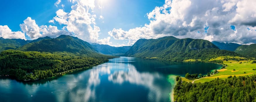 Aerial view of Bohinj lake in Julian Alps. Popular touristic destination in Slovenia. Bohinj Lake, Church of St John the Baptist. Triglav National Park, Julian Alps, Slovenia. 