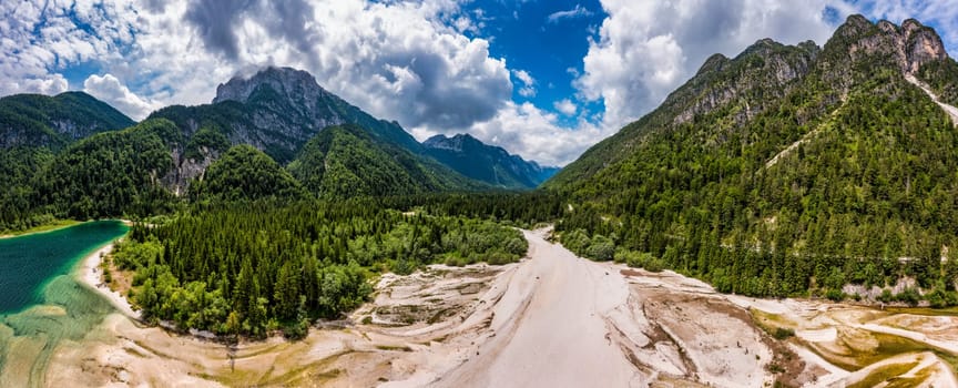 View to Julian Alps mountains above Predil lake in Italy with small lake. Predil Lake, Friuli Italy / (Lago del Predil), beautiful alpine lake in north Italy near the Slovenian border, Italy.