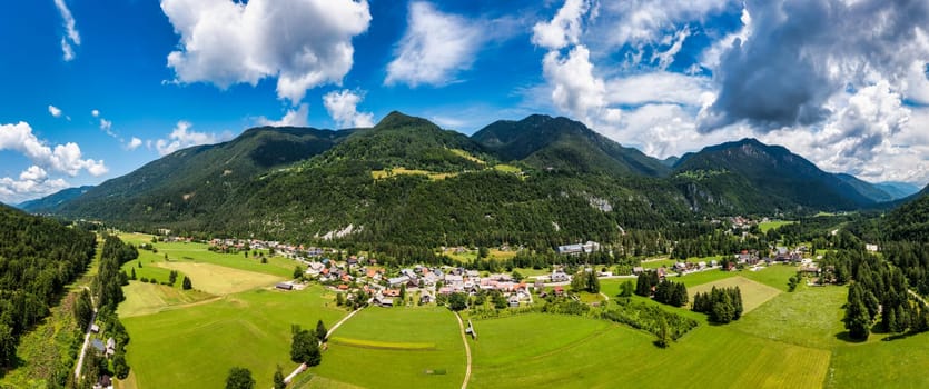 Gozd Martuljek town in Slovenia at summer with beautiful nature and mountains in the background. View of mountain landscape next to Gozd Martuljek in Slovenia, view from the top of Gozd Martuljek.
