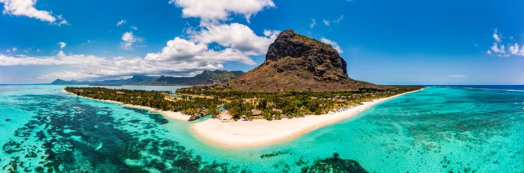 Aerial view of Le morne Brabant in Mauriutius. Tropical crystal ocean with Le Morne mountain and luxury beach in Mauritius. Le Morne beach with palm trees, white sand and luxury resorts, Mauritius.