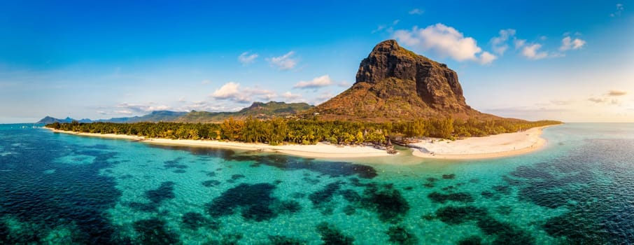 Aerial view of Le morne Brabant in Mauriutius. Tropical crystal ocean with Le Morne mountain and luxury beach in Mauritius. Le Morne beach with palm trees, white sand and luxury resorts, Mauritius.