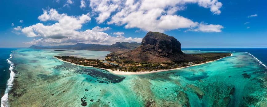 Aerial view of Le morne Brabant in Mauriutius. Tropical crystal ocean with Le Morne mountain and luxury beach in Mauritius. Le Morne beach with palm trees, white sand and luxury resorts, Mauritius.