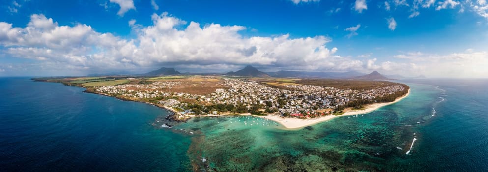 Beautiful Mauritius Island with gorgeous beach Flic en Flac, aerial view from drone. Mauritius, Black River, Flic-en-Flac view of oceanside village beach and luxurious hotel in summer.