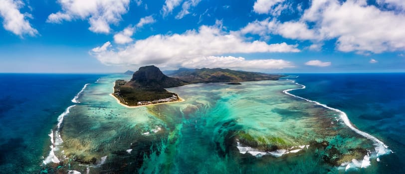 Aerial view of Mauritius island panorama and famous Le Morne Brabant mountain, beautiful blue lagoon and underwater waterfall. Le Morne Brabant peninsula and Underwater Waterfall, Mauritius.