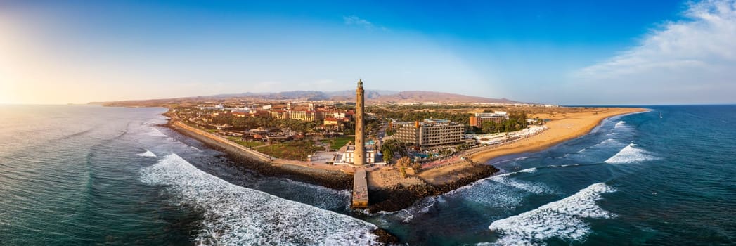 Lighthouse of Maspalomas at Gran Canaria Island known as Faro de Maspalomas at sunset. Seascape with lighthouse and Maspalomas beach. Gran Canaria, Canary Islands, Spain