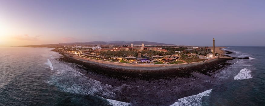 Lighthouse of Maspalomas at Gran Canaria Island known as Faro de Maspalomas at sunset. Seascape with lighthouse and Maspalomas beach. Gran Canaria, Canary Islands, Spain