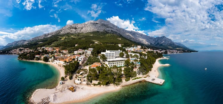 Beautiful Brela on Makarska riviera, Croatia. Adriatic Sea with amazing turquoise clean water and white sand. Aerial view of Brela town and waterfront on Makarska riviera, Dalmatia region of Croatia.