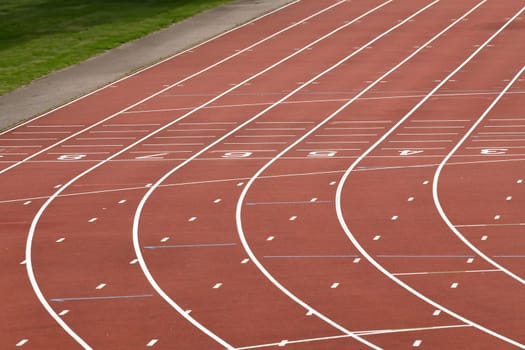 The red runway is numbered in a stadium