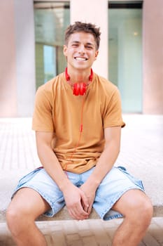 Attractive confident Caucasian teenage student looking at camera outdoors. Boy standing with happy face.