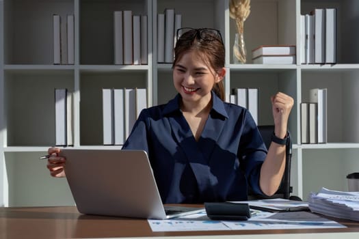 A businesswoman shows joy in celebrating the success of her work in achieving the goals she set..