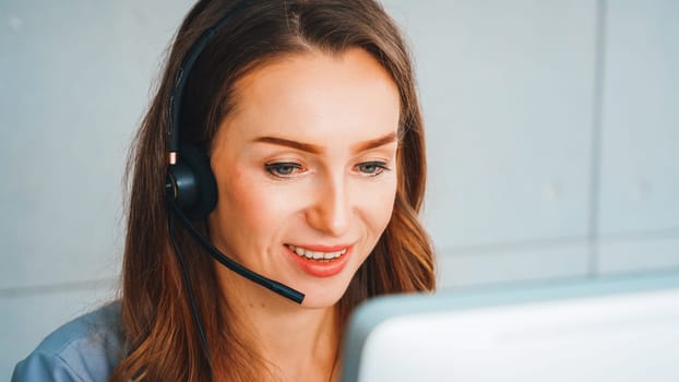 Business people wearing headset working in office to support remote customer or colleague. Call center, telemarketing, customer support agent provide service on telephone video conference call. Jivy