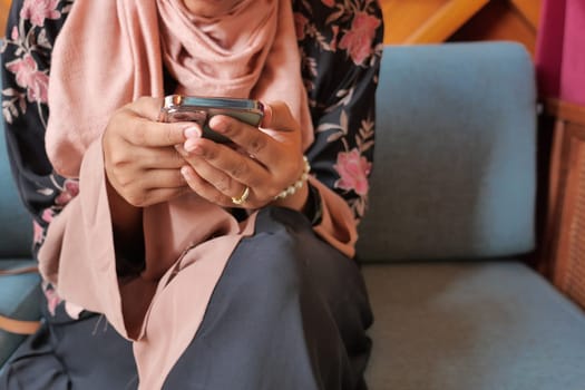 close up of women hand holding smart phone.