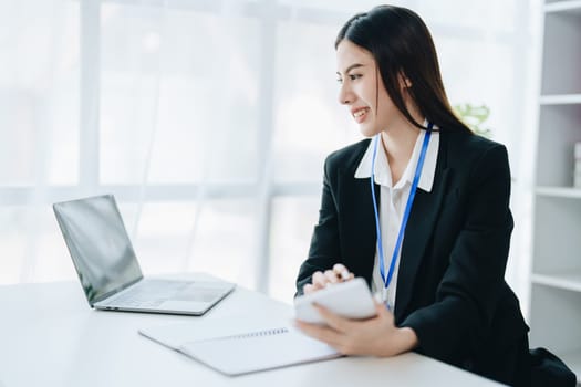 Young asian female work with financial papers at home count on calculator before paying taxes receipts online, planning budget glad to find chance for economy saving money, audit concepts.