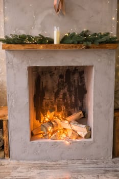 Fireplace decorated for Christmas. The interior of the Scandinavian-style living room, decorated for the Christmas holidays