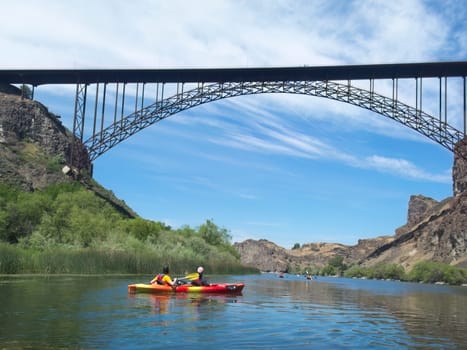 A vacationing family is kayaking on the Snake River near the Perrine Bridge in Twin Falls, Idaho.