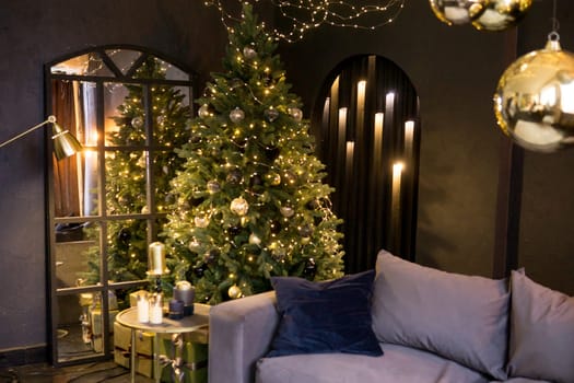Christmas interior with a beautiful Christmas tree, sofa, light bulbs and dark background