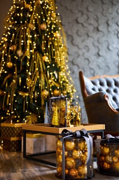 Luxurious interior of the room for Christmas and New Year. Living room in gray and gold tones with a sofa, many gifts, golden balls, ice lights, two Christmas trees
