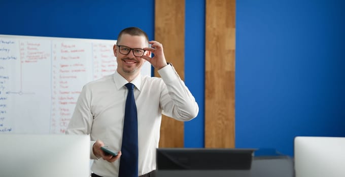 Male business coach smiling, close-up, blurry. Staff training, motivation and inspiration in the workplace