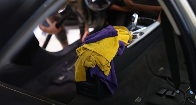 Microfiber towels in the car, interior cleaning, close-up, blurry. Professional car dry cleaning service