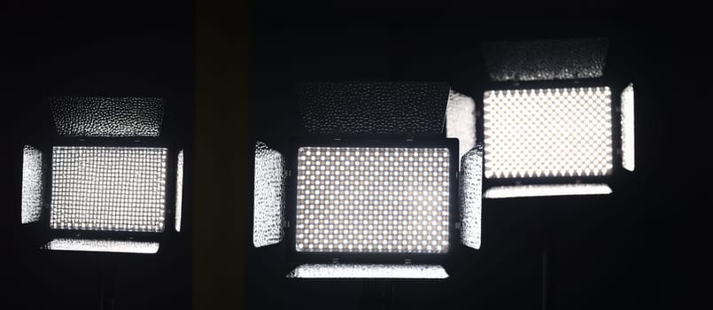Two luminous LED panels for photography on a black background. Photo panel lighting LED photography with tripod