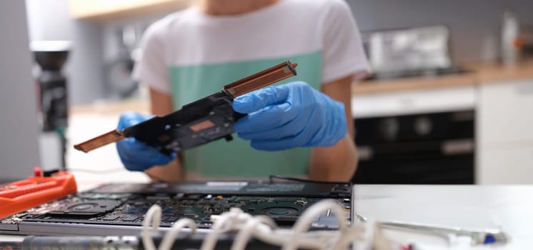 Repairman hands hold pc microcircuit, close-up, blurry. Broken computer part, device soldering, repair processor