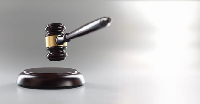 Brown judge's gavel on a gray background, close-up. The concept of an unfair trial, corruption in the judicial system