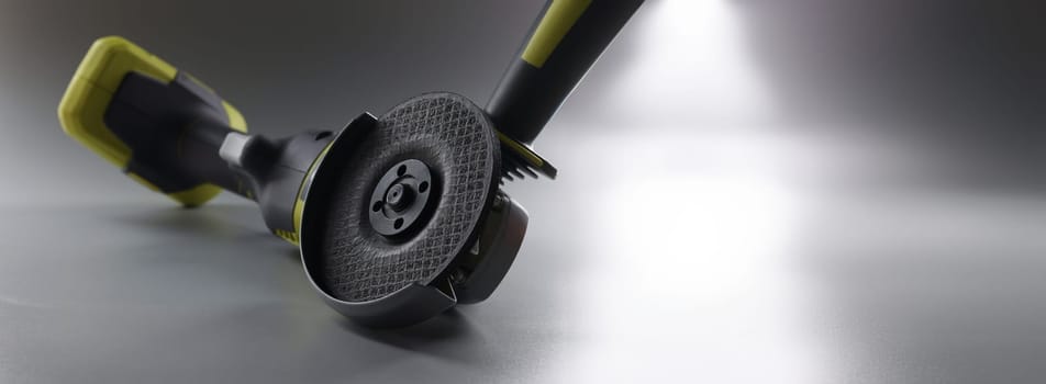 Cordless hand sander on a gray background, close-up. Electric power tools. DIY repair, construction equipment