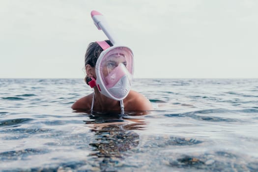 Young happy woman in white bikini put pink snorkeling mask on beach before swimming. girl having fun relaxing on beautiful beach. Beach lifestyle