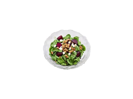 Salad baby spinach with roasted beets goat cheese and walnuts served in a transparent glass. Food isolated on transparent background.