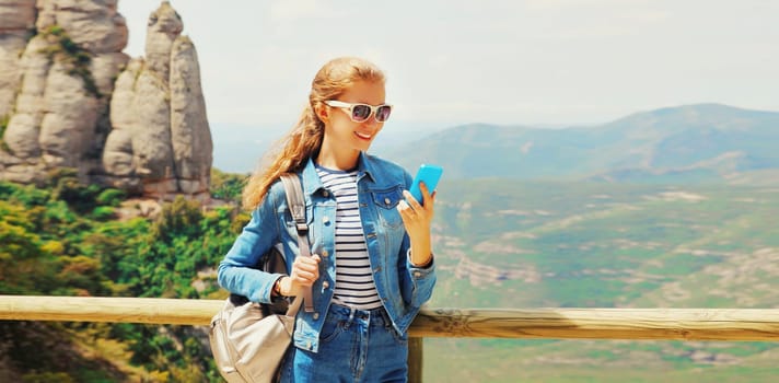 Travel, happy young woman tourist looking at phone with backpack on mountain Montserrat background