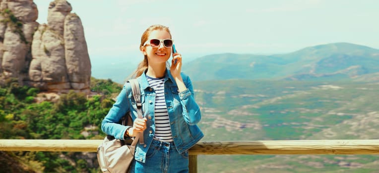 Travel, happy young woman tourist calling on phone on hiking trail on top of the mountain Montserrat