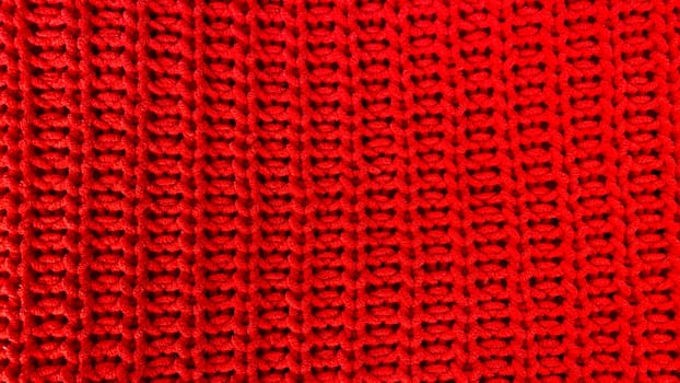 Red knitted wool fabric texture as background
