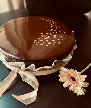 The mousse cake is decorated with chocolate mirror glaze. Modern dessert. High quality photo