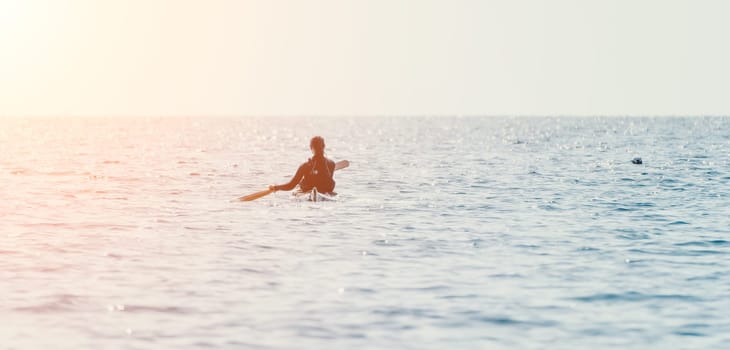 Happy smiling woman in kayak on ocean, paddling with wooden oar. Calm sea water and horizon in background