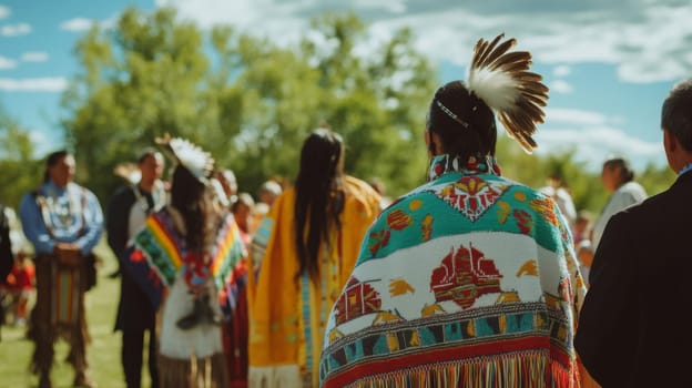 Participants in traditional attire gather for a cultural ceremony, surrounded by nature and vibrant colors, celebrating heritage under a bright blue sky.