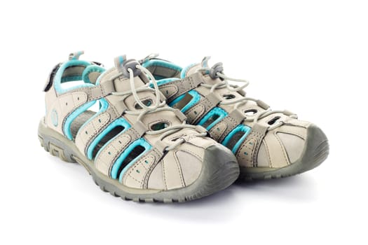 Pair of beige and blue sport sandals isolated on white background. Product photography for design and print. Footwear and outdoor activity concept.