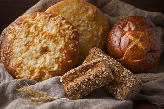 A close up still life photo of various loafs of natural whole bread.