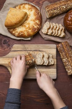 An overview of cutting up slices of whole grain baguette on a cutting board.