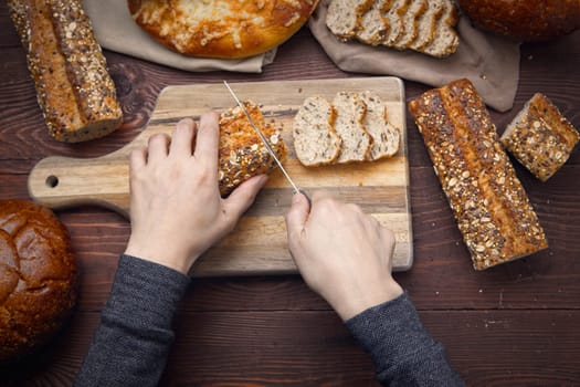 An overview of cutting up slices of whole grain baguette on a cutting board.