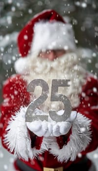Santa claus hands holding 25 number symbolizing new year and future concepts, close up view